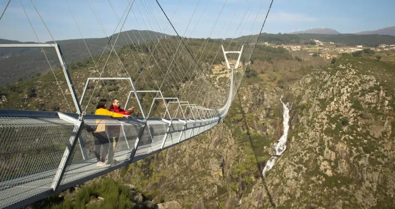 Person crossing the long suspension bridge above a gorge
