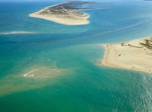 Aerial view of sandbars and turquoise shallows of a lagoon