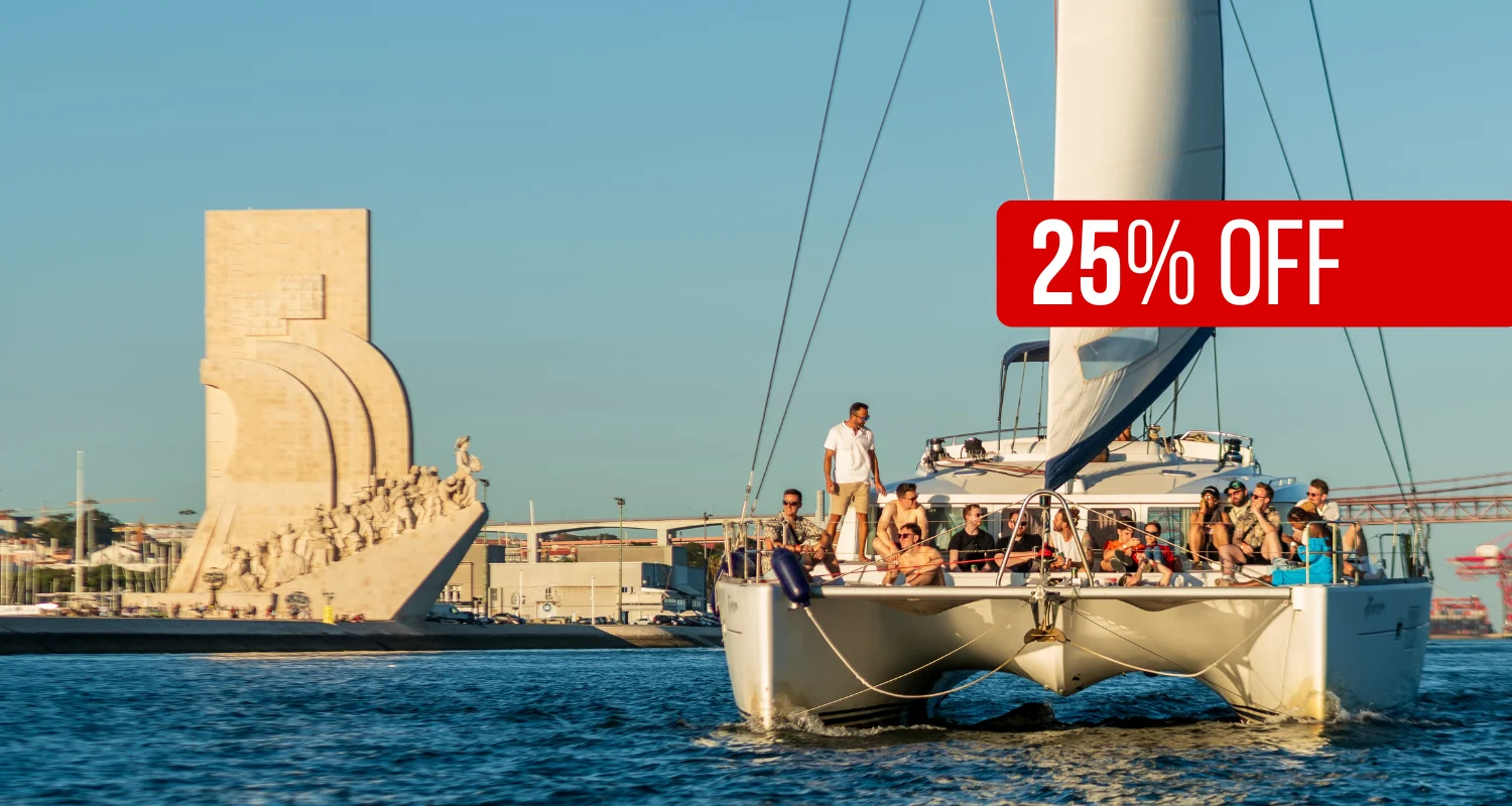 Catamaran with guests near the Monument to the Discoveries, with a '25% off' banner