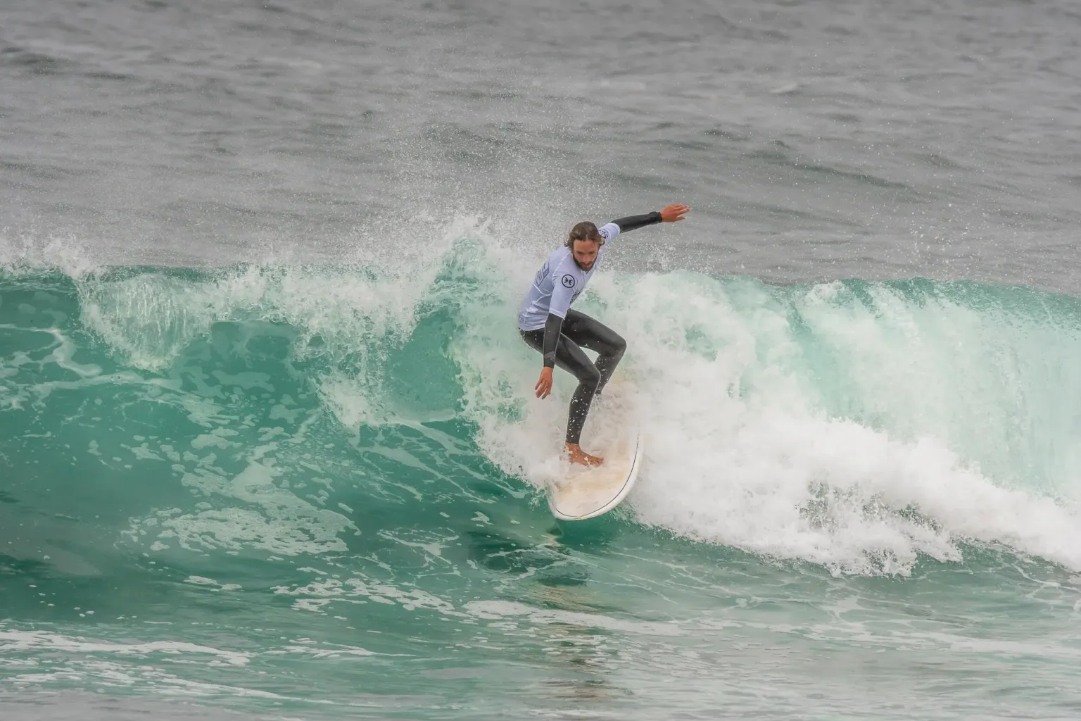 Surfer riding a green wave